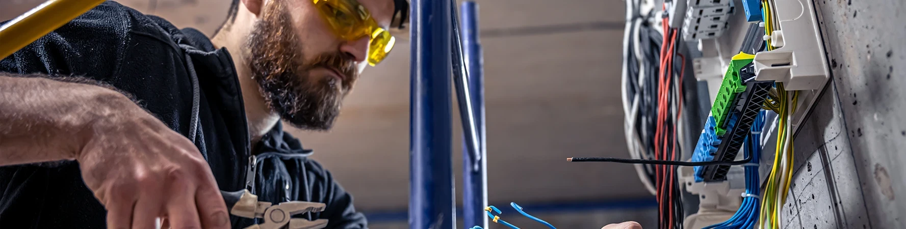 Electrical Technician Certificate electrician working on electric panel