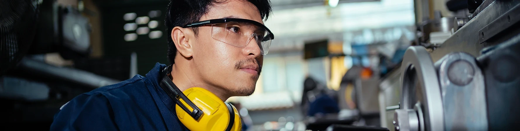 IST Maintenance Certificate male operating grinding lathes working in industrial plant