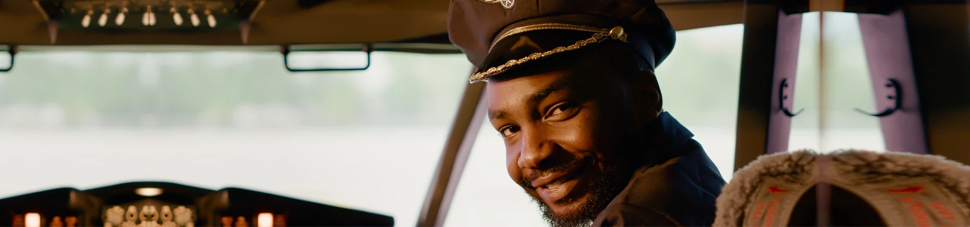 Manned Pilot Diploma male captain sitting in airplane cockpit