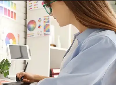 Graphic Arts & Imagining Technology student working at her desk