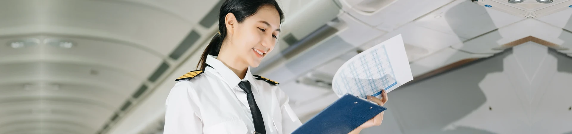 female pilot in uniform checking flight plan